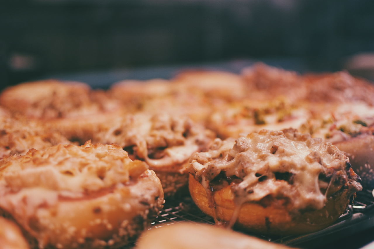 Close-up of bagel pizza on metal grate