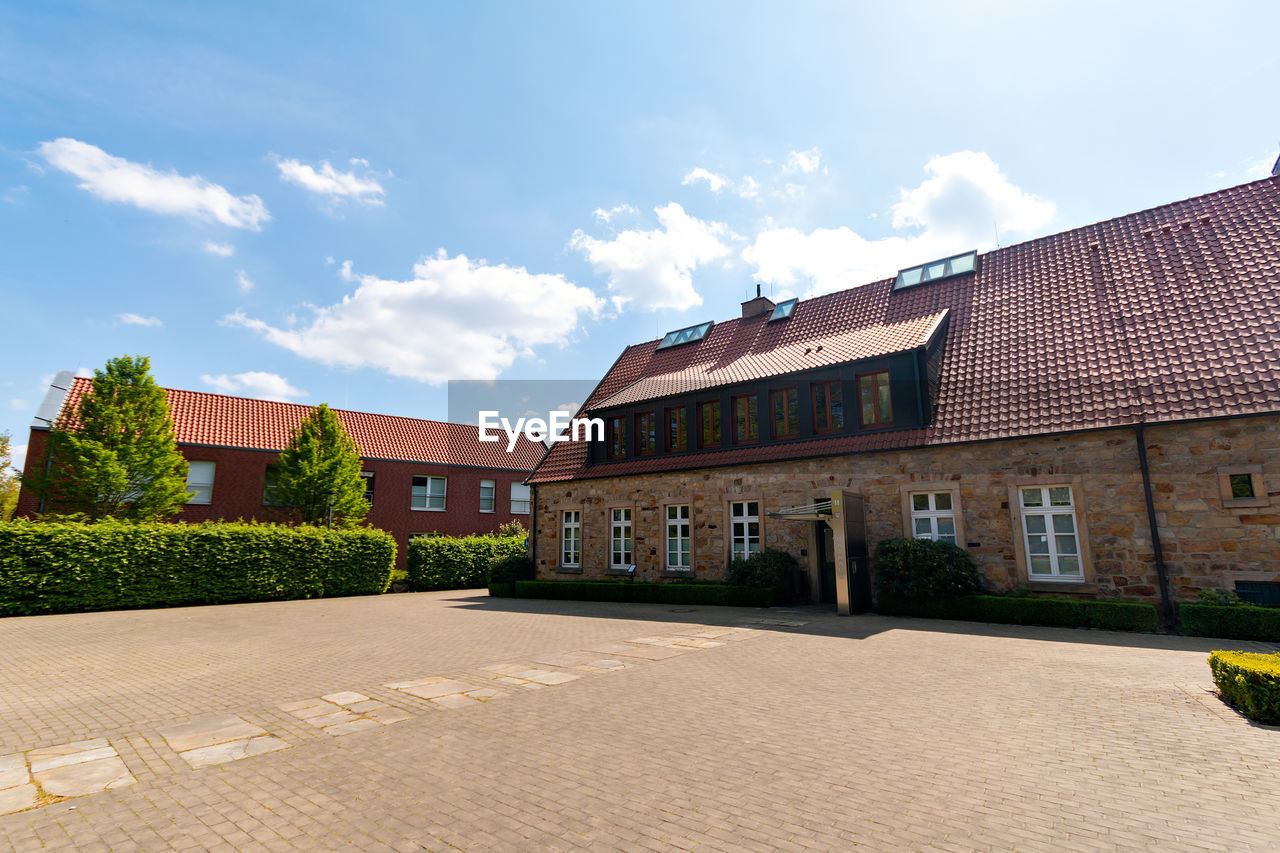 Building by street against sky