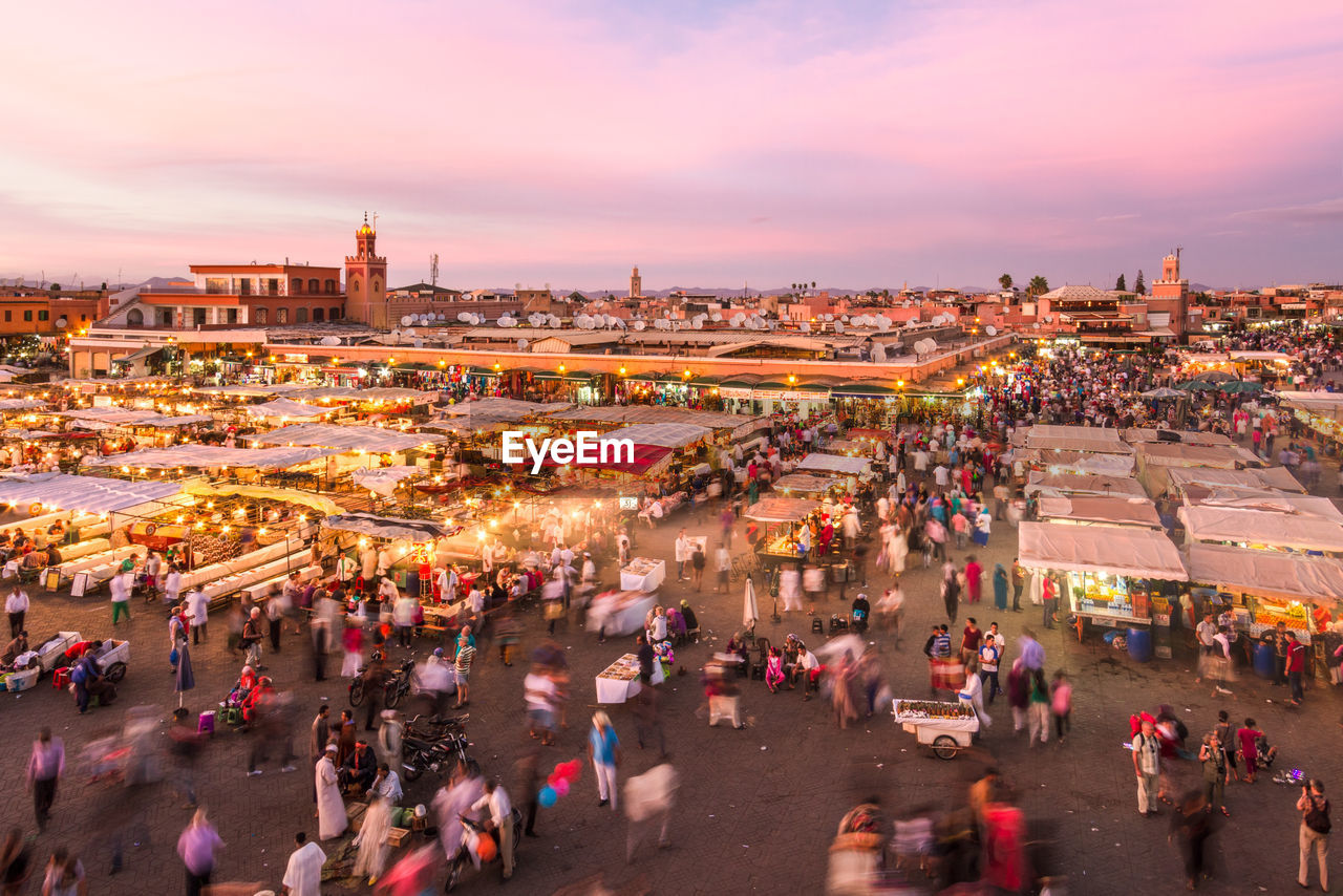 HIGH ANGLE VIEW OF PEOPLE AT MARKET