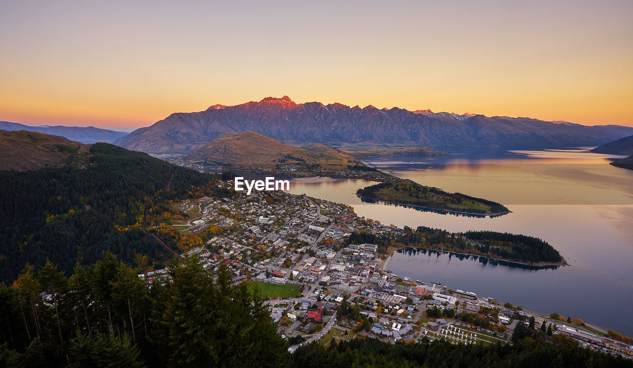 Aerial view of queenstown by lake during sunset