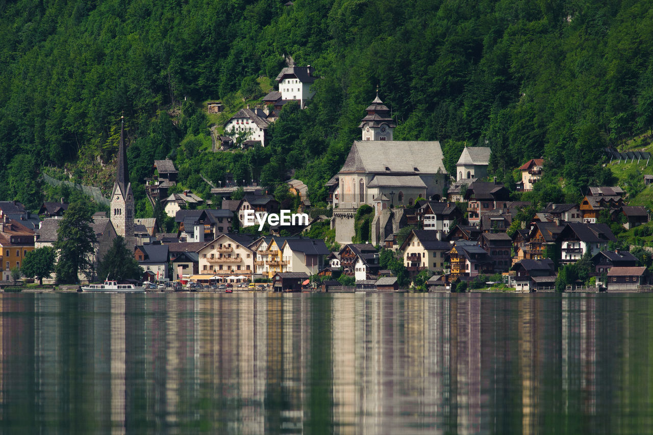 Houses by lake and buildings in town