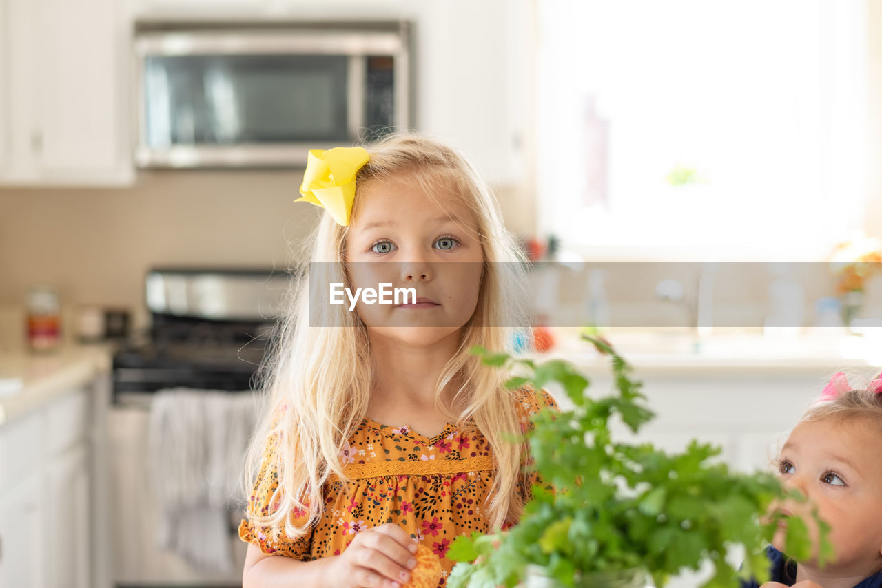 Cute kids preparing food on table at home