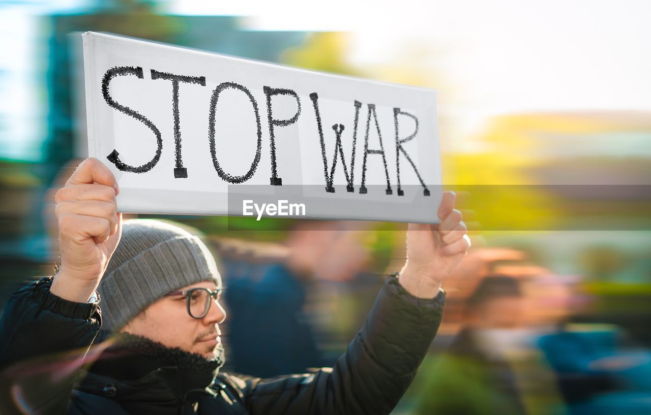 Protestor holding banner at anti-war rally