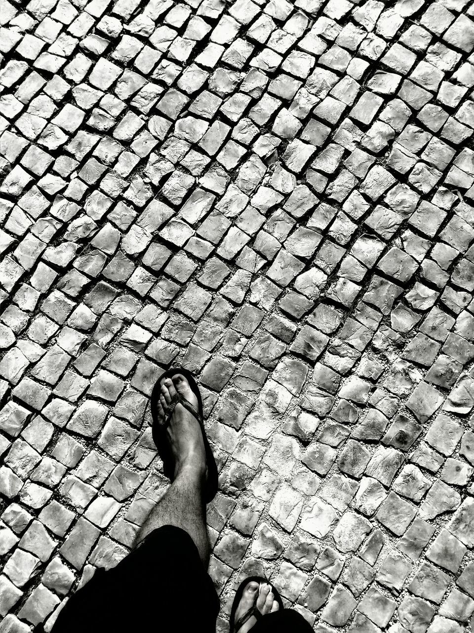 Low section of man walking on sidewalk