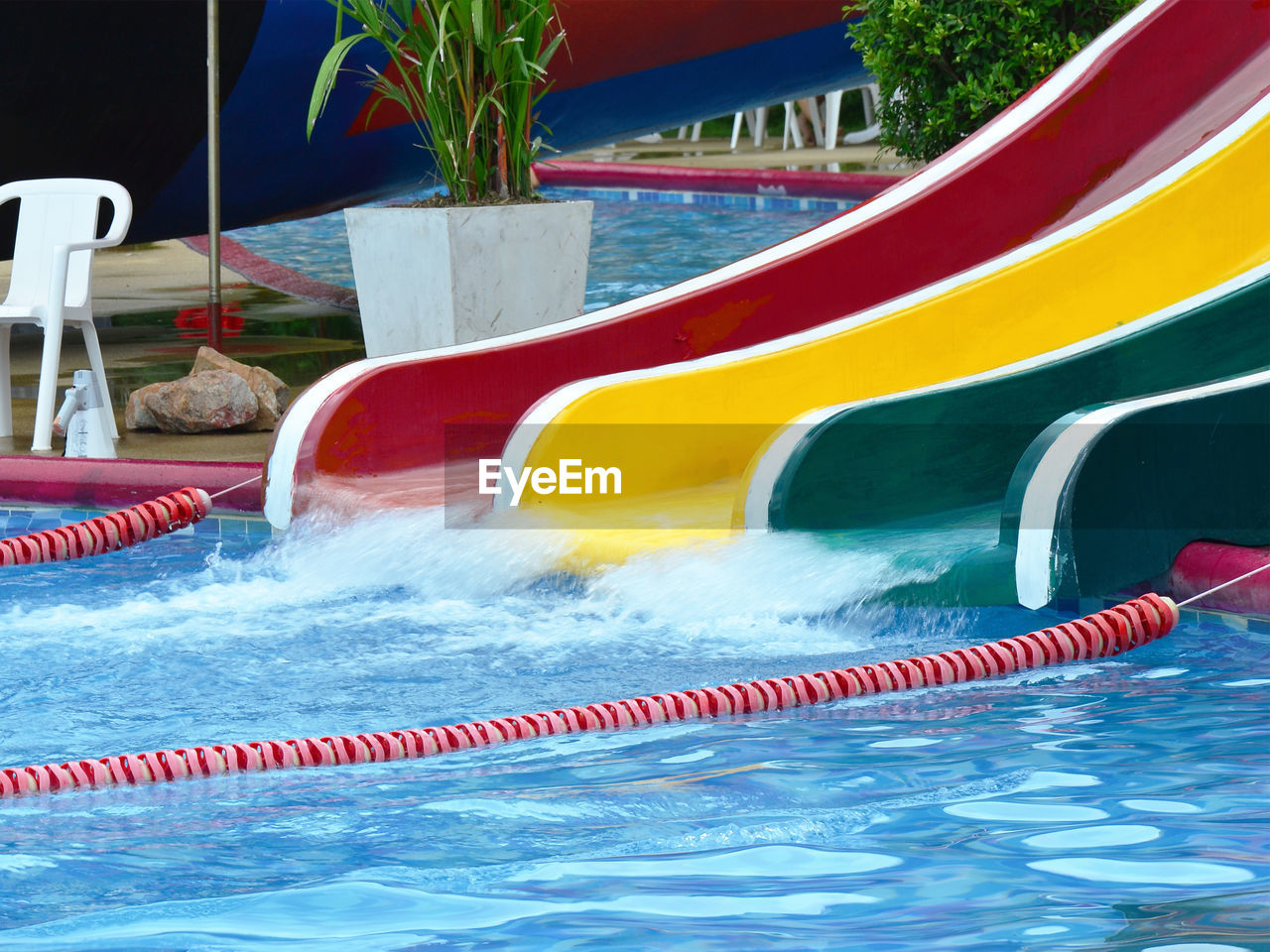 CLOSE-UP OF RED SWIMMING POOL IN WATER