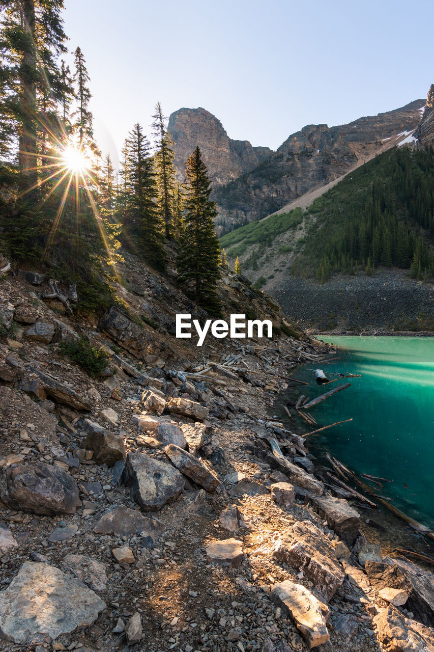 Scenic view of lake and mountains against clear sky