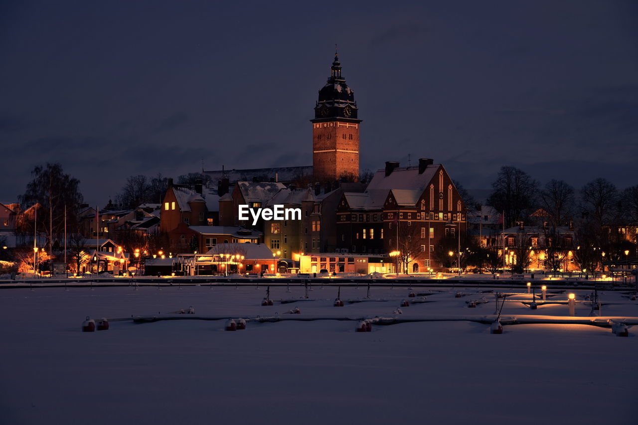 ILLUMINATED BUILDINGS IN CITY AT NIGHT