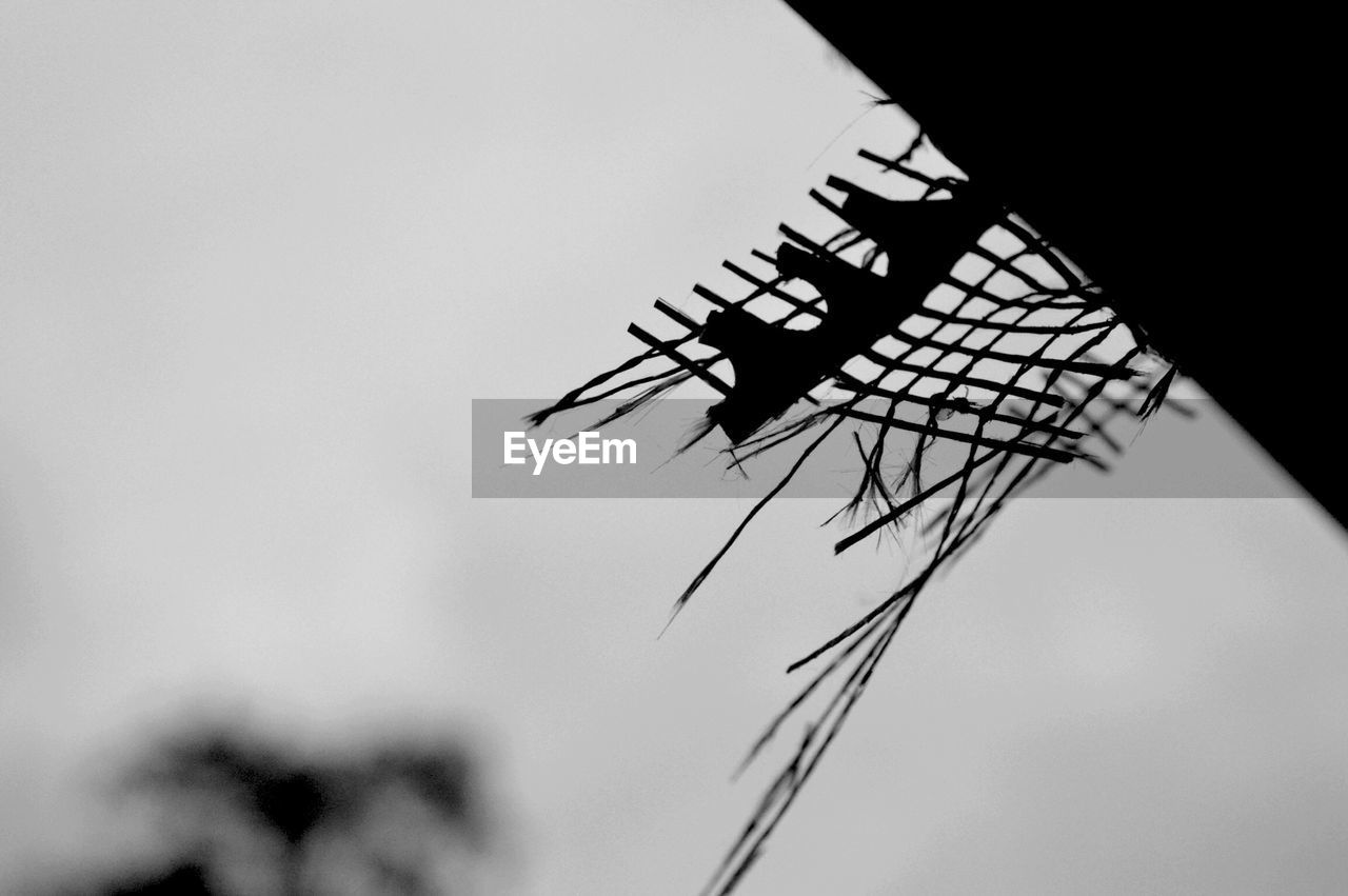 Low angle view of threads on roof against clear sky