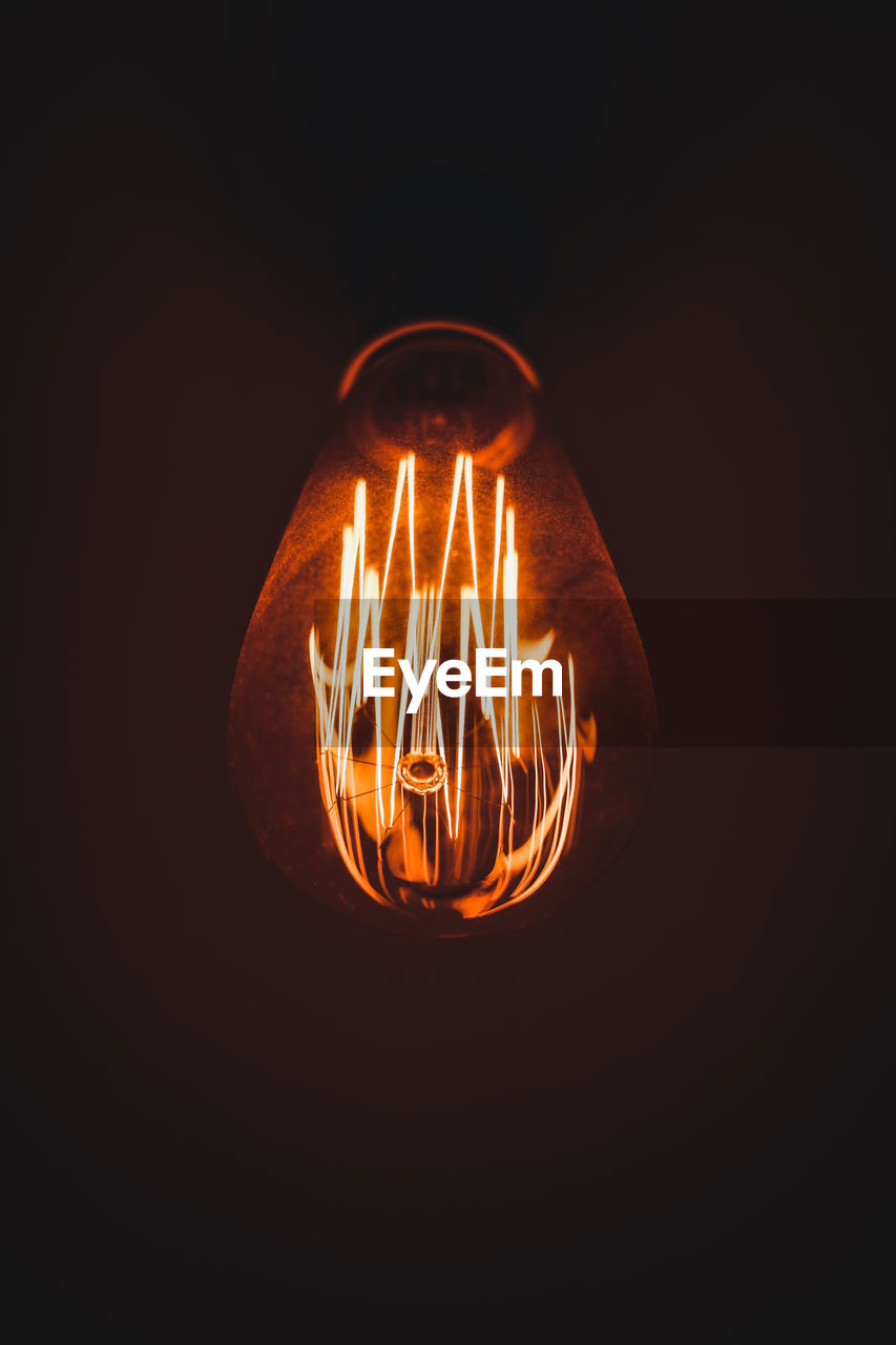 CLOSE-UP OF ILLUMINATED LIGHT BULB