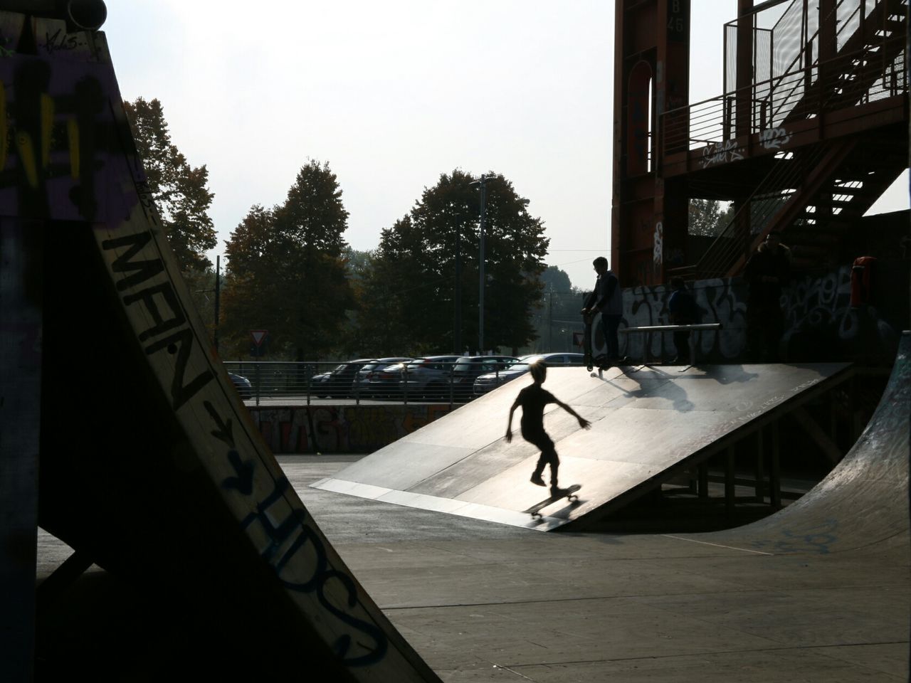 MAN WALKING ON RAILING AGAINST BUILDINGS