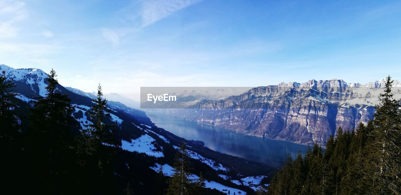 Scenic view of mountains against blue sky