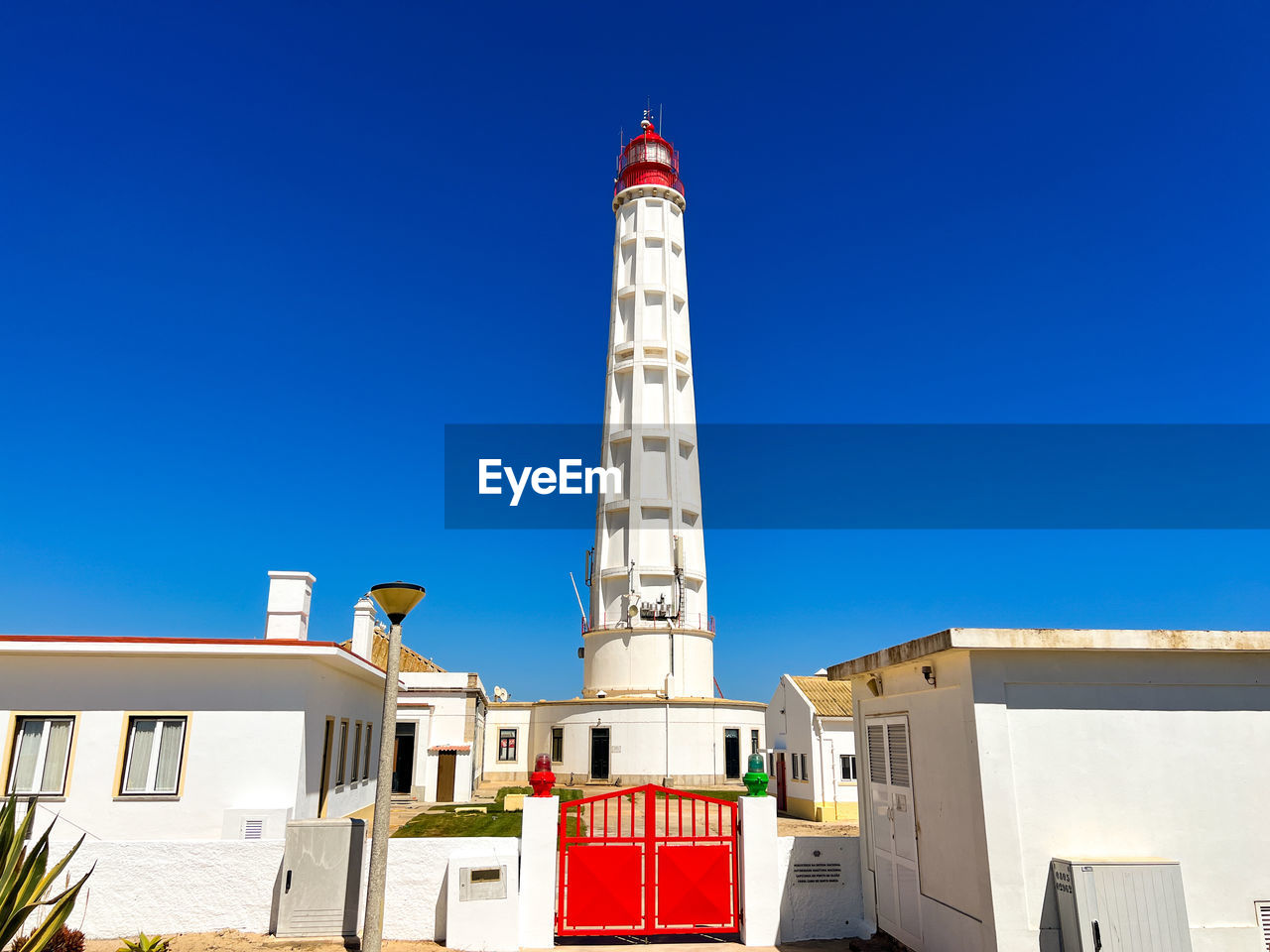 Low angle view of lighthouse against clear blue sky