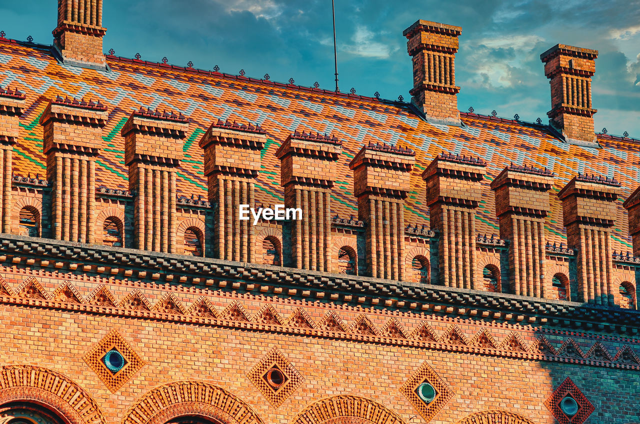 Decorative elements roof of old house, university in chernivtsi. red brick house