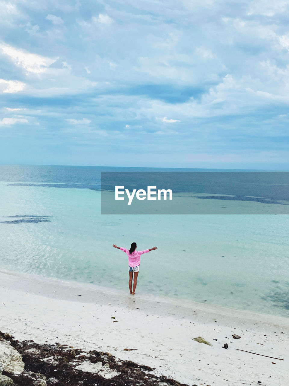 Full length of woman on beach against sky