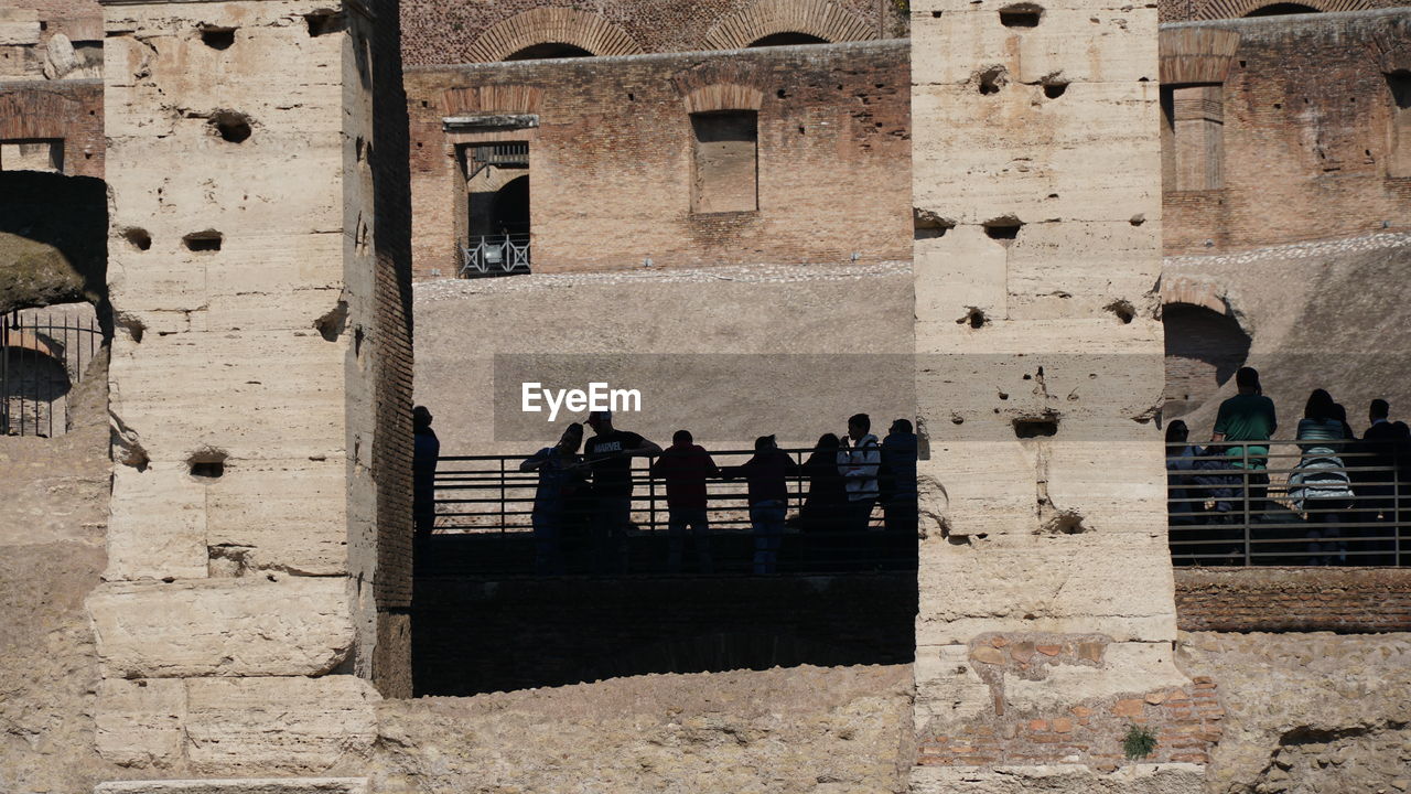 GROUP OF PEOPLE AT OLD BUILDING