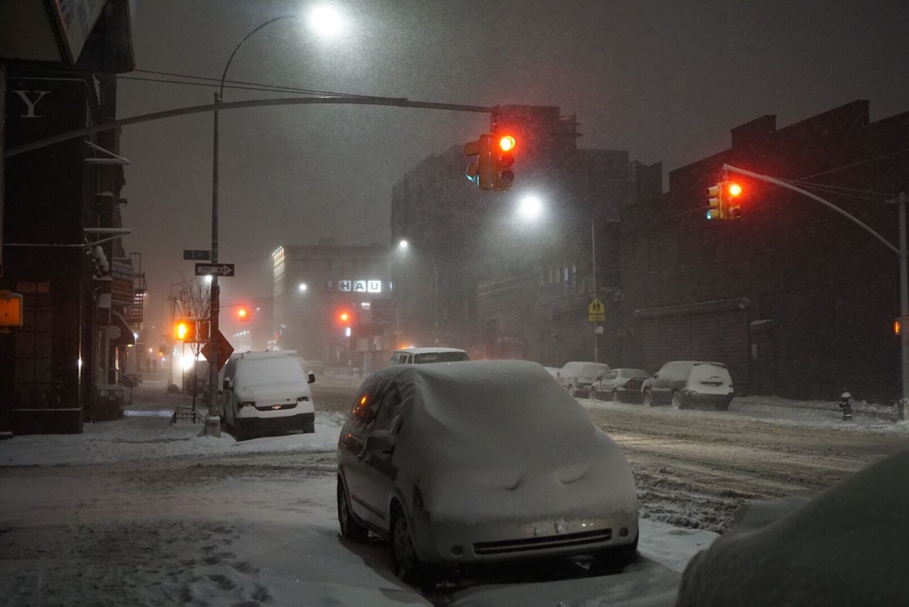 CAR ON SNOW COVERED ROAD