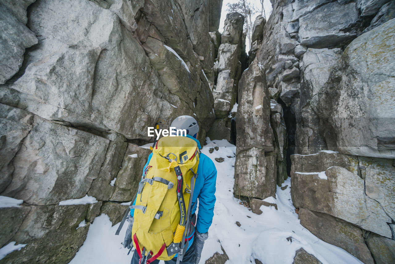 Ice climber scrambling up gully