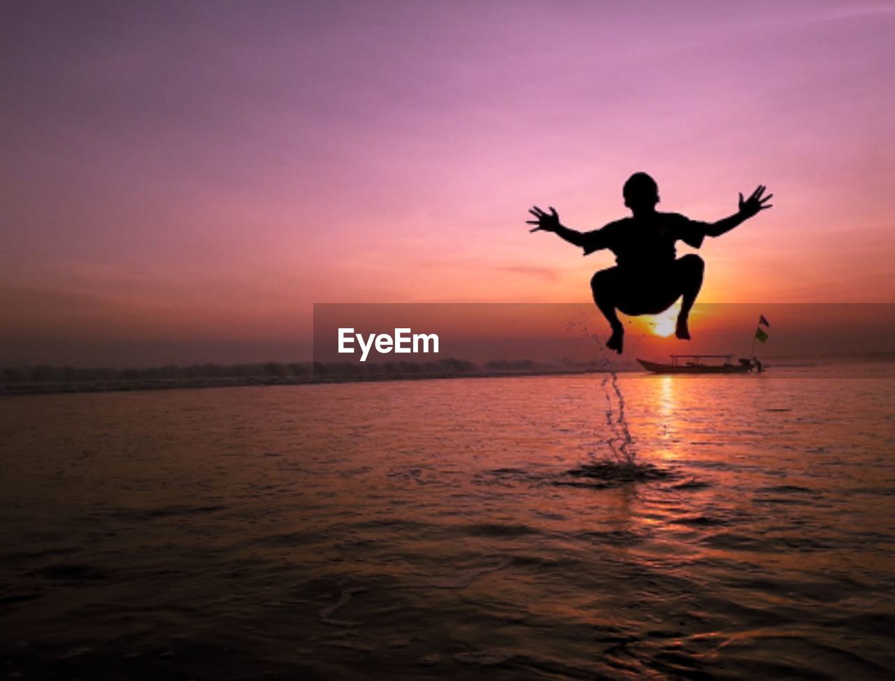 Silhouette man on beach during sunset