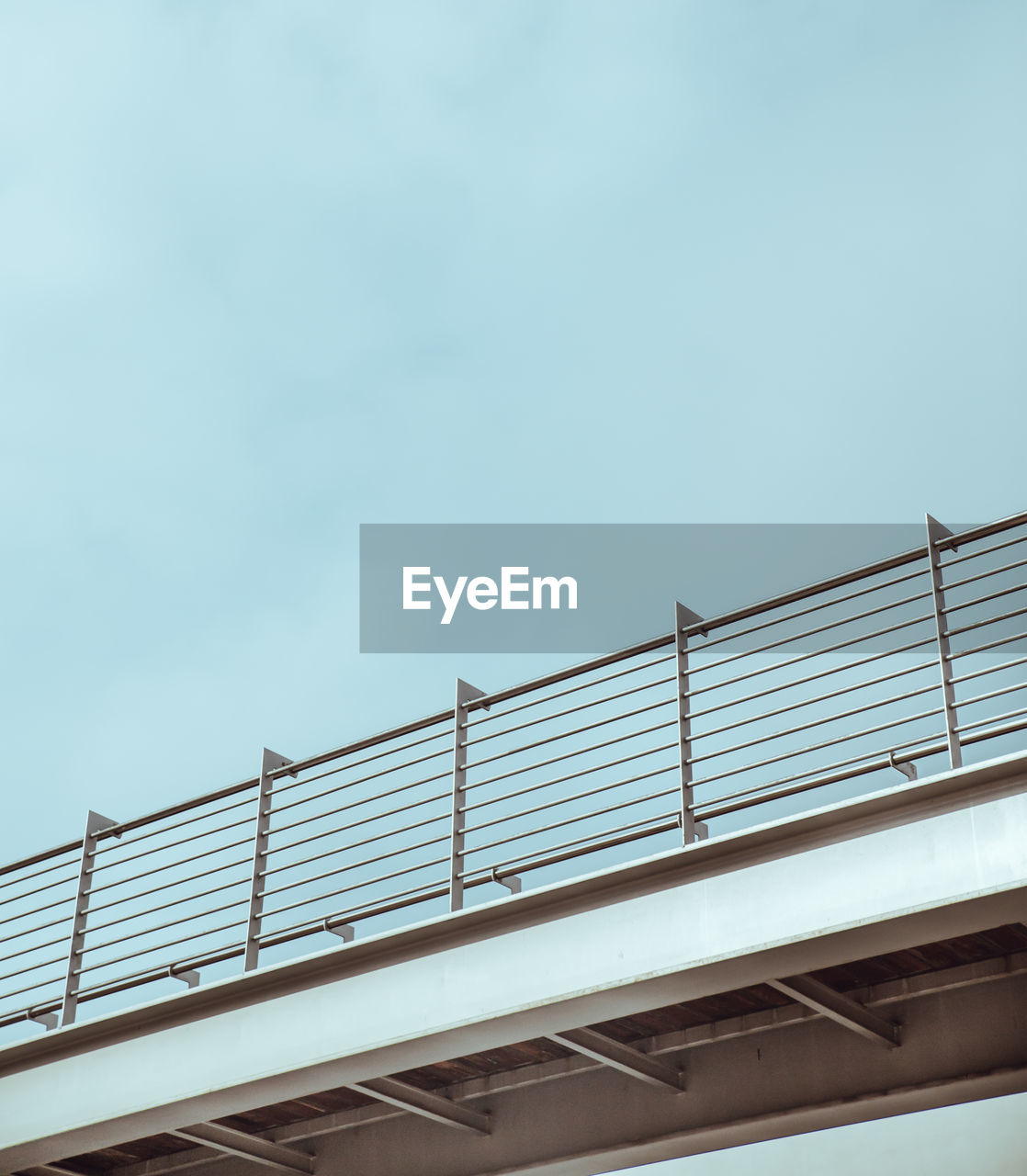 LOW ANGLE VIEW OF RAILROAD BRIDGE AGAINST SKY