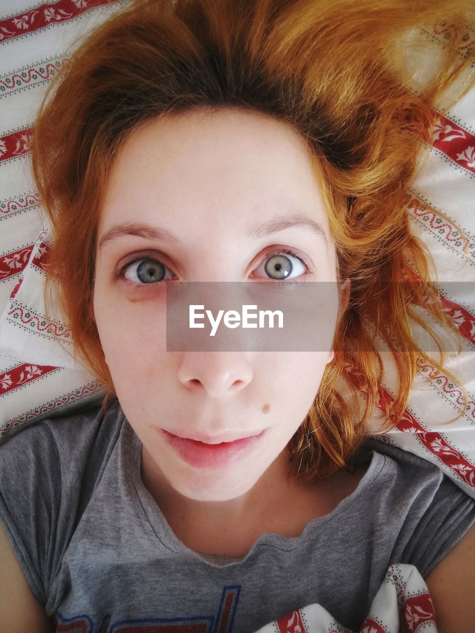 High angle portrait of girl lying on bed