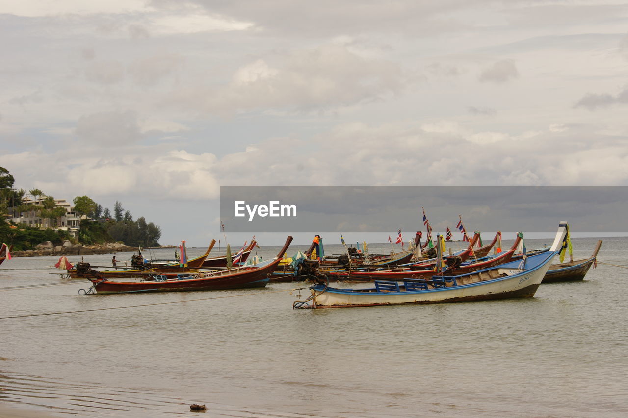 Boats on shore against sky