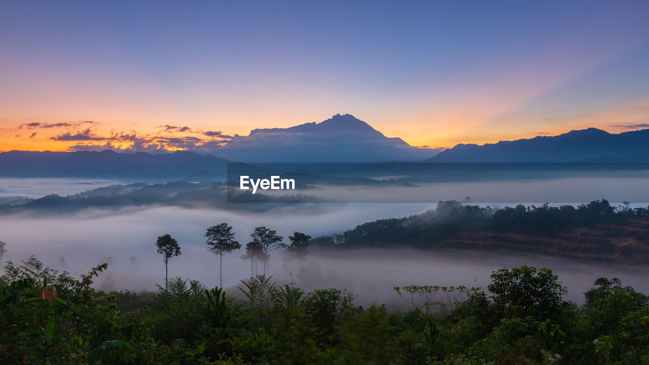 SCENIC VIEW OF LANDSCAPE AGAINST SKY DURING SUNSET