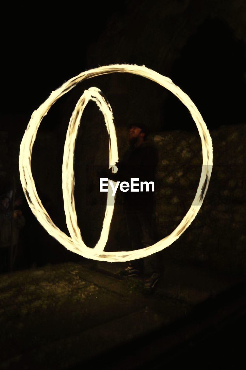 MAN SEEN THROUGH METAL GRATE