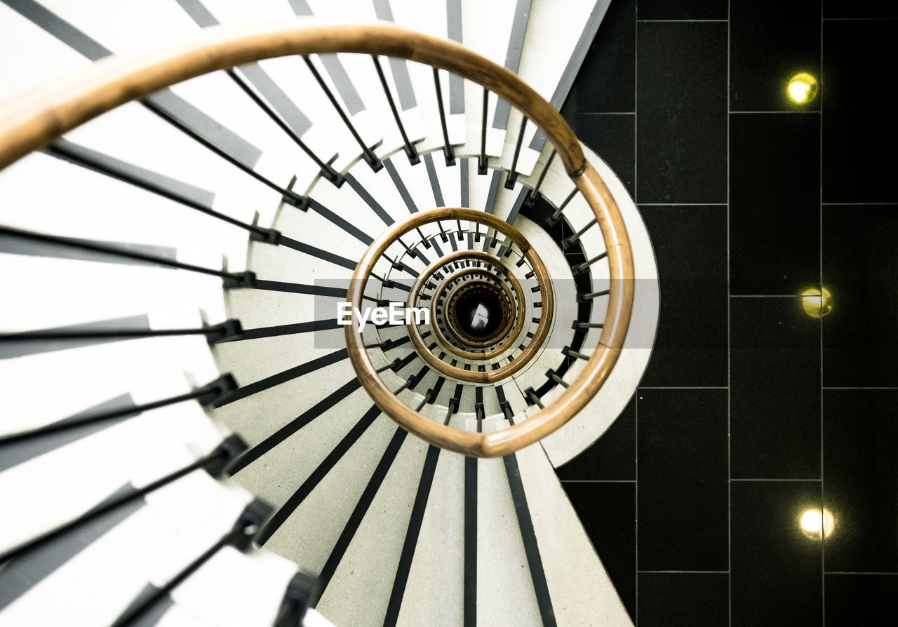 DIRECTLY BELOW SHOT OF SPIRAL STAIRCASE ON BUILDING