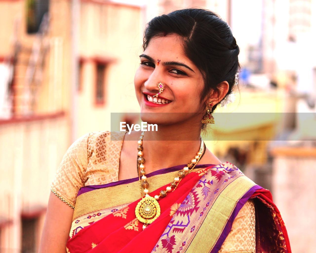 Portrait of smiling young woman wearing sari outdoors