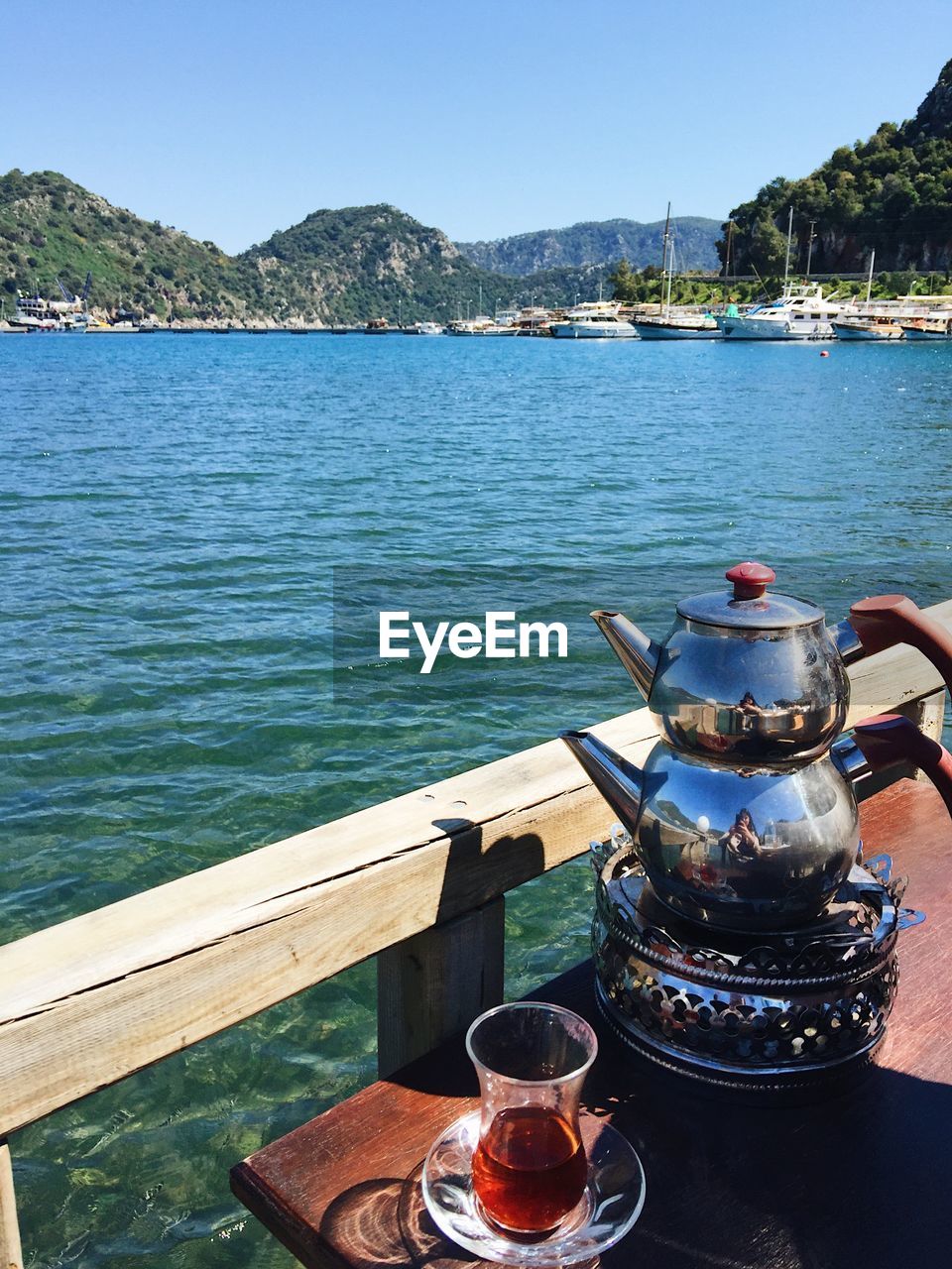 Close-up of tea kettle on boat sailing in sea