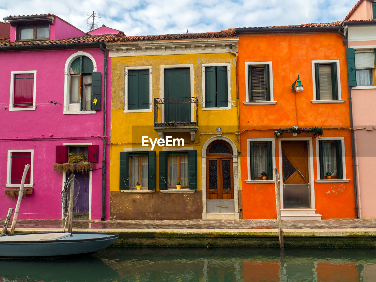 boats moored in front of house