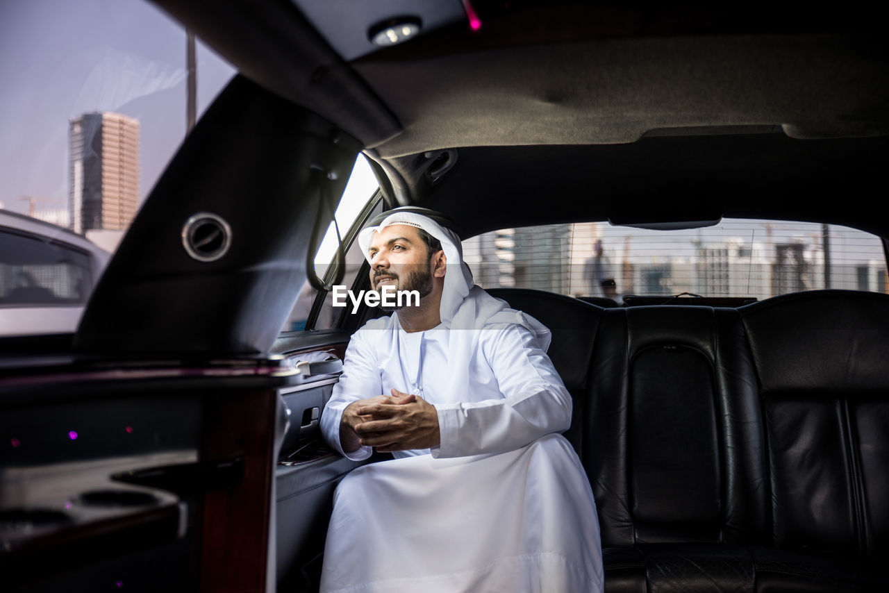 Arab businessman sitting in car