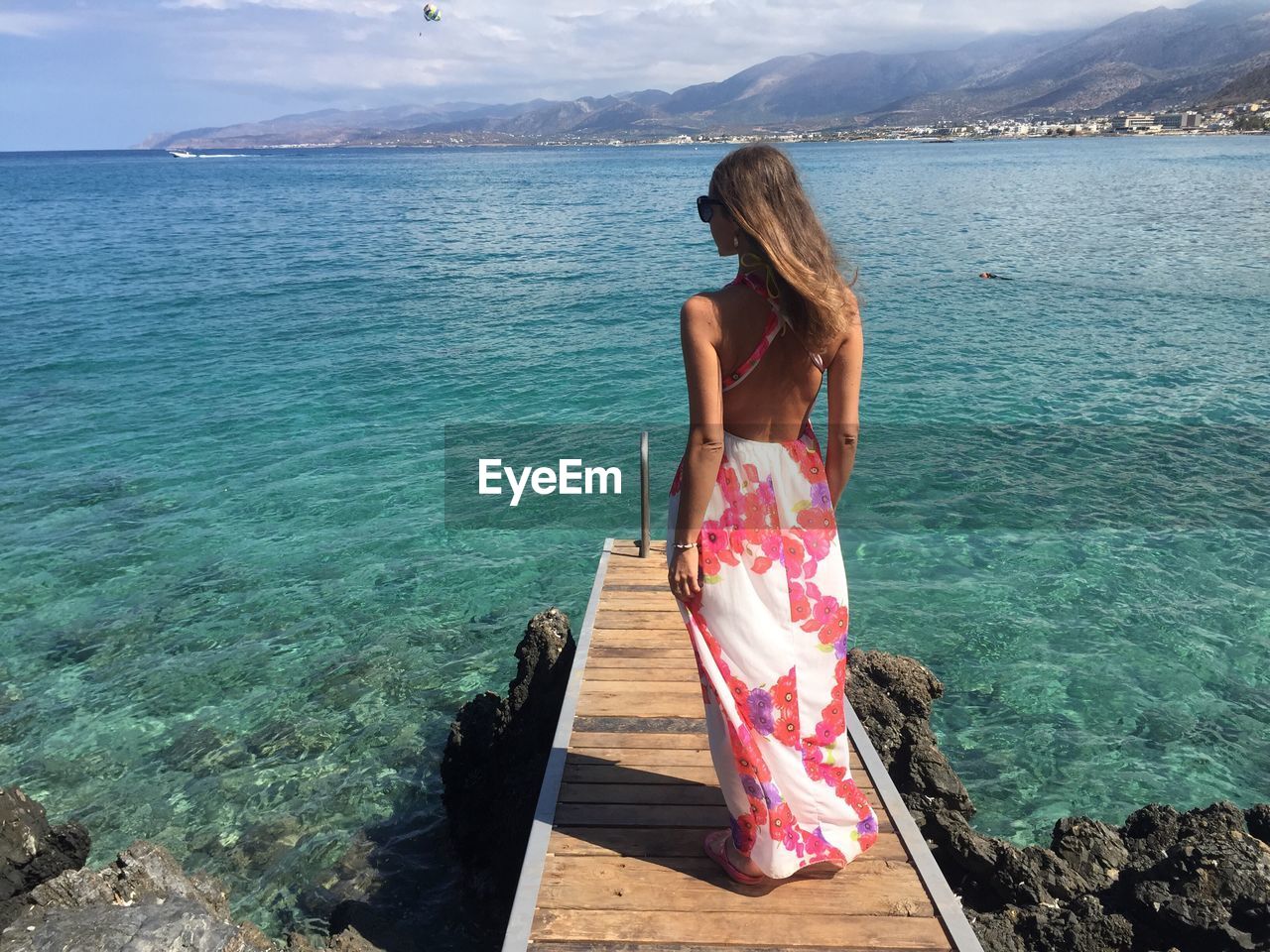 Rear view of woman standing on beach