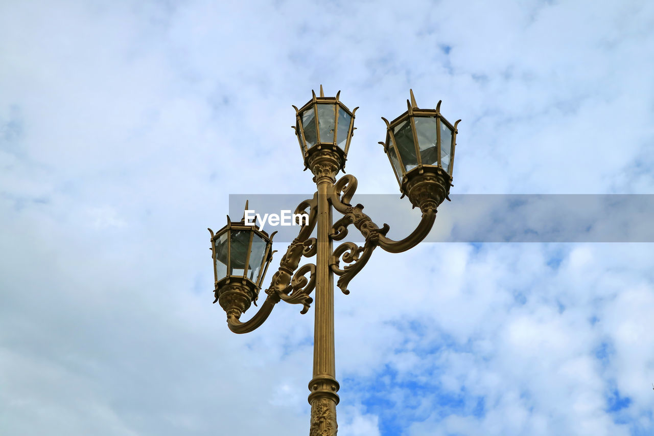 Beautiful art nouveau style street lamps against cloudy sky of buenos aires, argentina