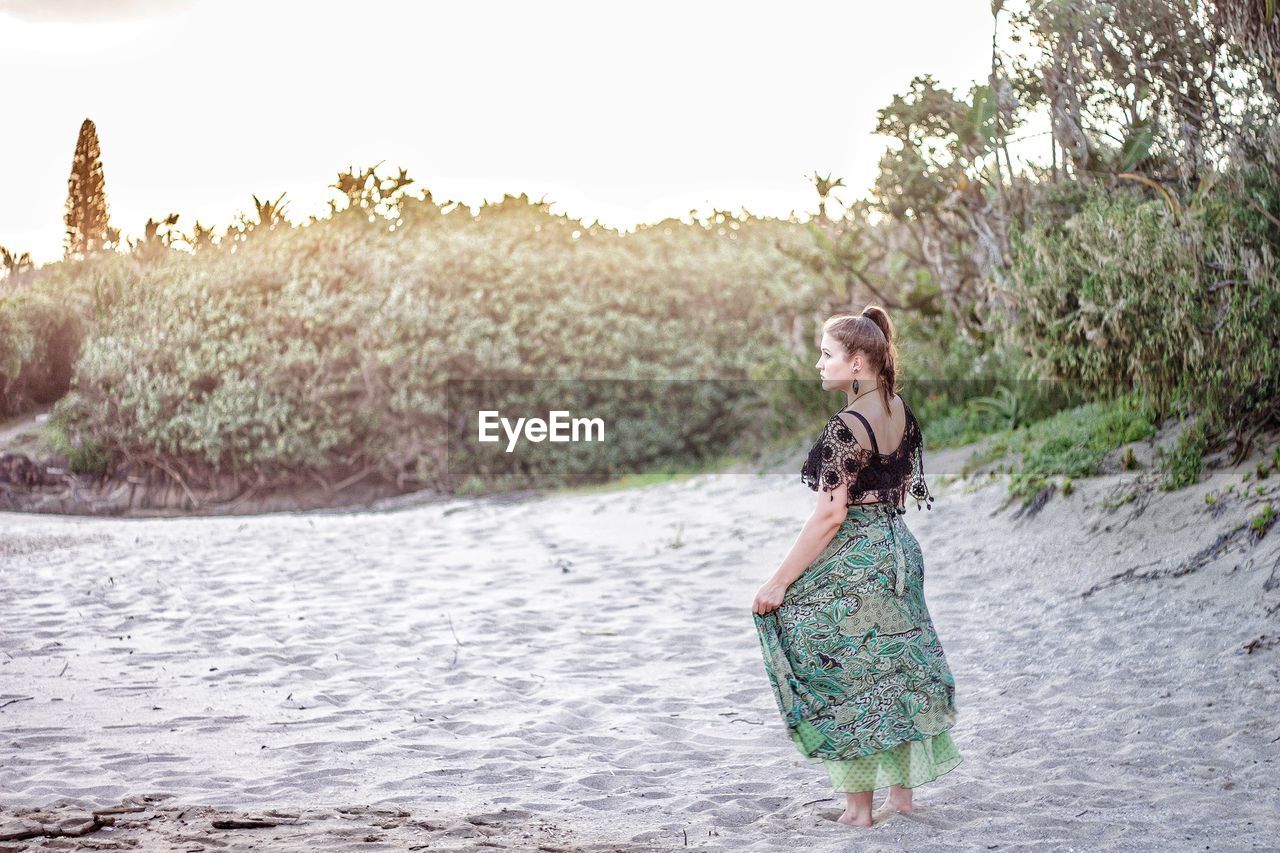 Full length of woman standing on sand