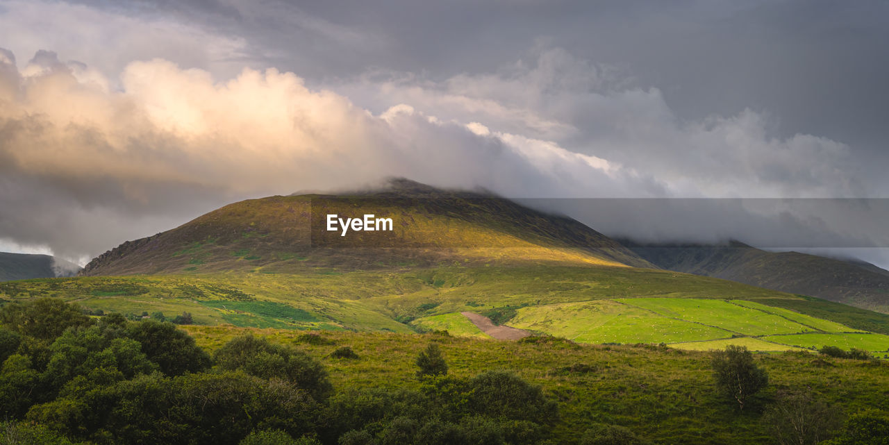 Beautiful sunrise, sunlight illuminating  foothill of carrauntoohil, ring of kerry, ireland