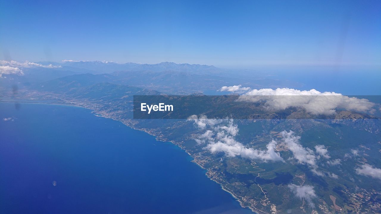 Aerial view of landscape against blue sky