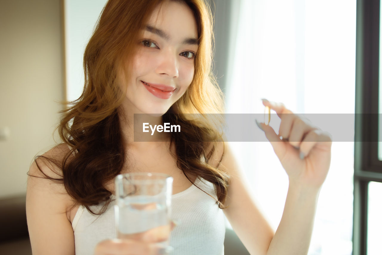 Portrait of beautiful woman drinking glass