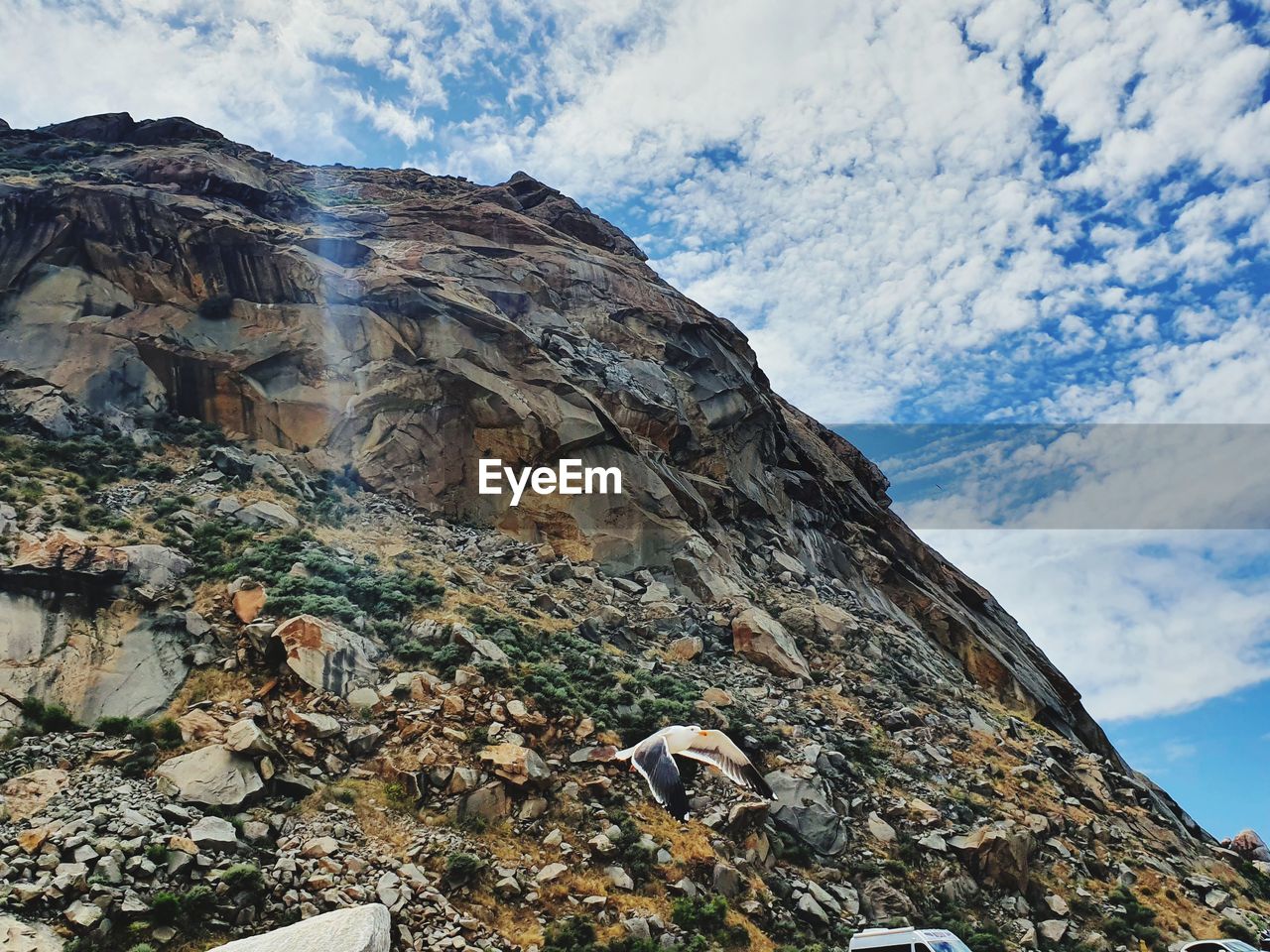 Low angle view of rock formation against sky