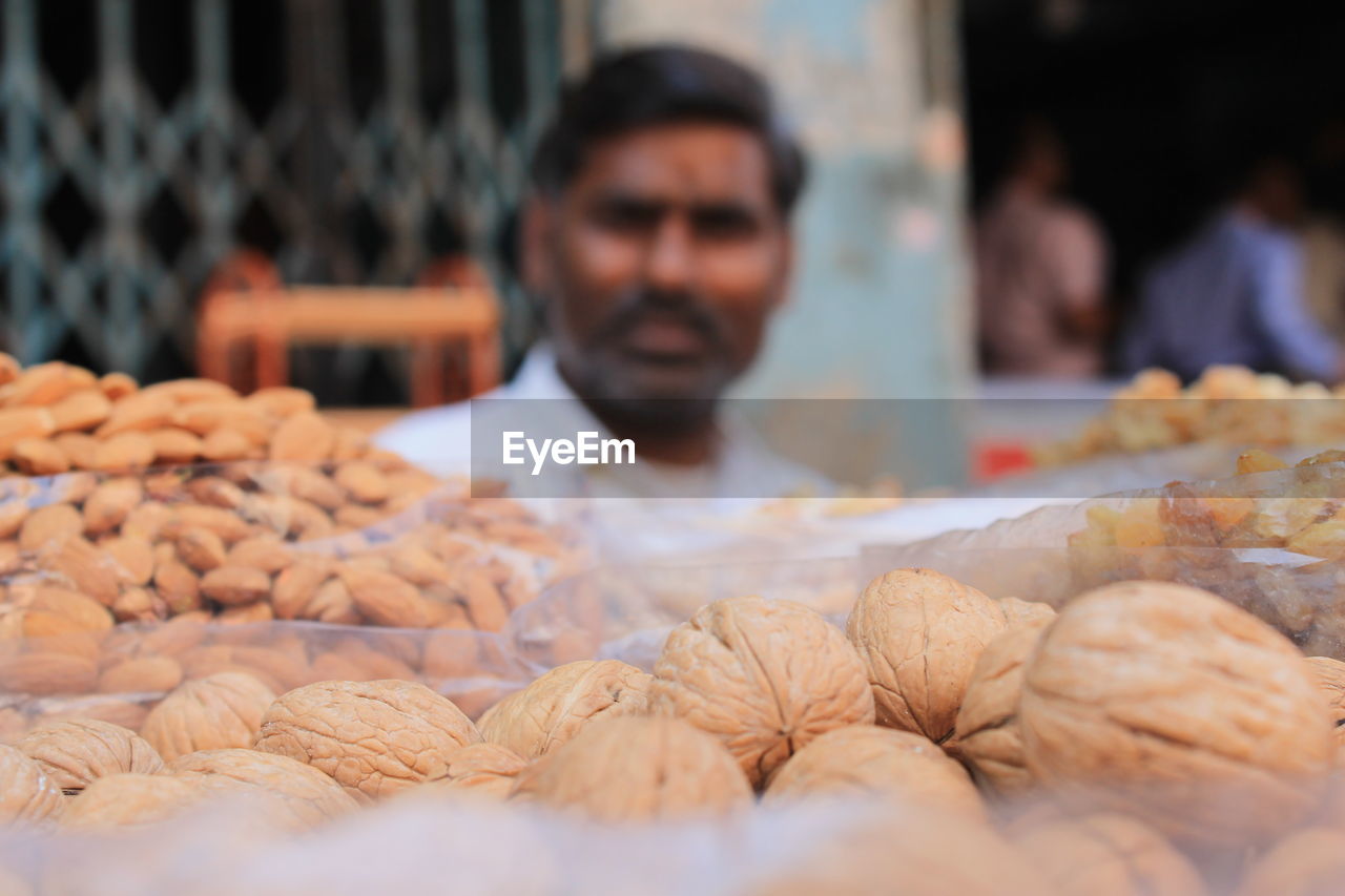 Man selling dried fruits at market stall