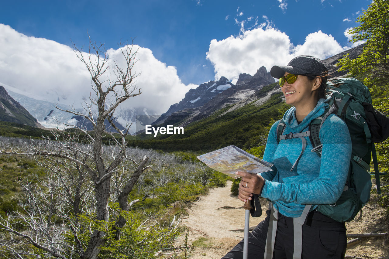 Woman hiking in the andes mountain range towards cerro torre