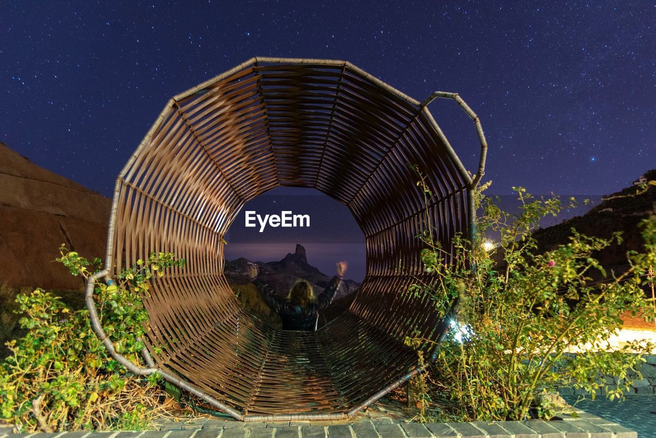 DIGITAL COMPOSITE IMAGE OF ILLUMINATED BUILDING AGAINST SKY