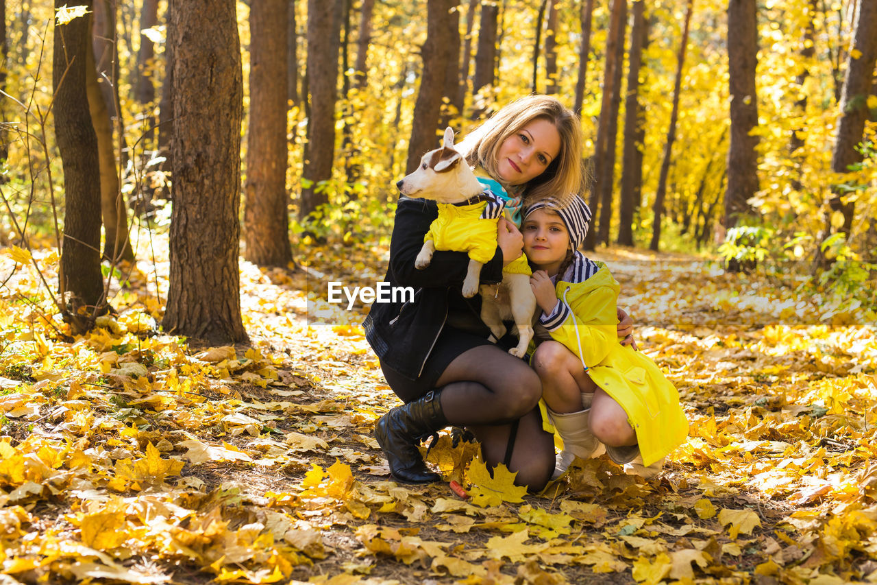 FULL LENGTH OF A GIRL WITH AUTUMN LEAVES