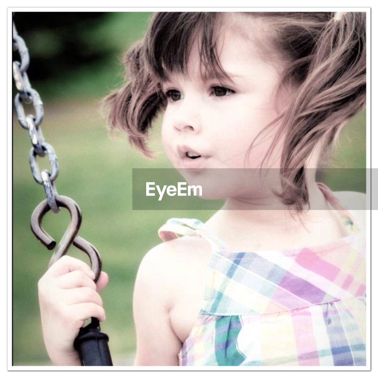 Close-up of cute girl on swing