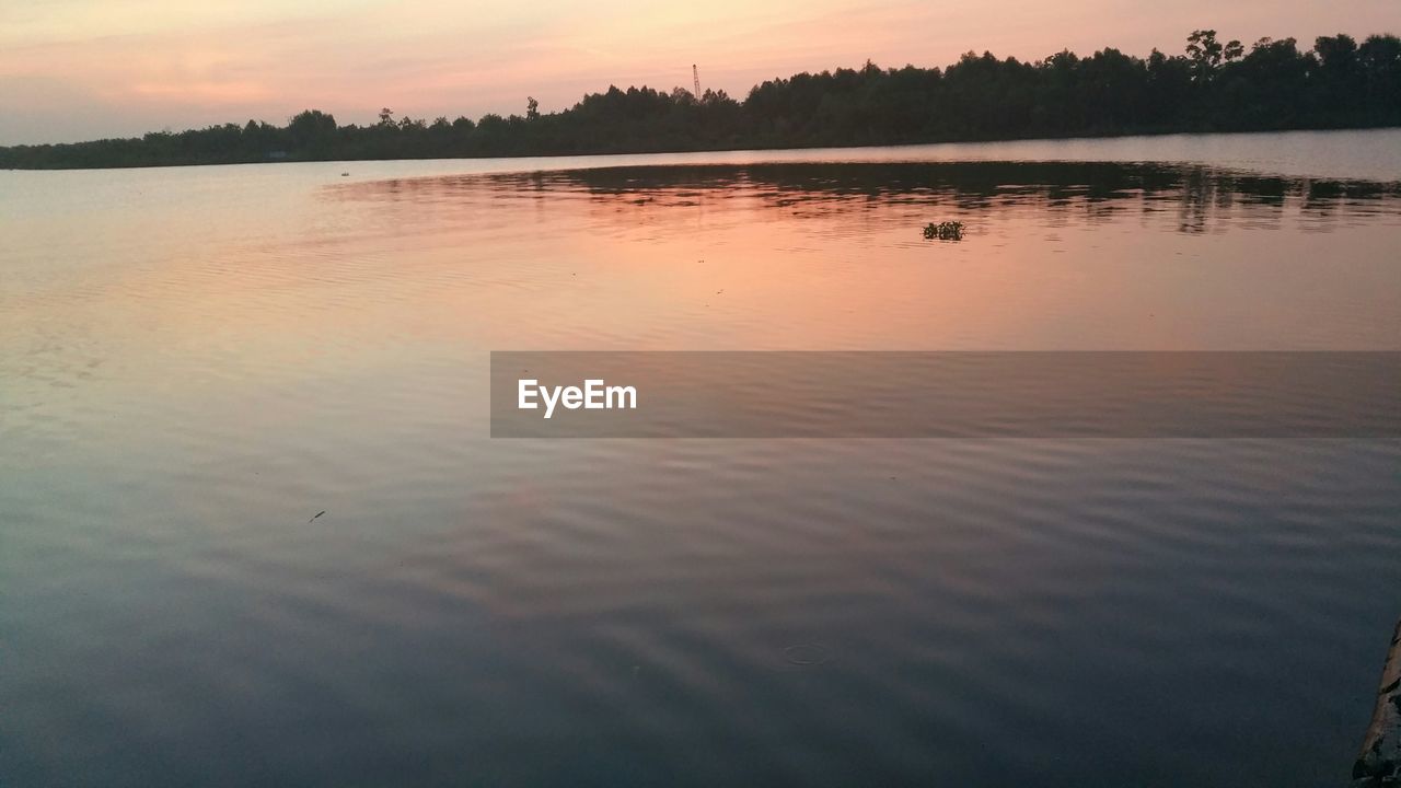 SCENIC VIEW OF LAKE AT SUNSET