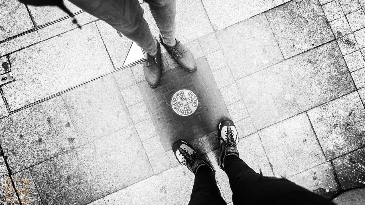 LOW SECTION OF WOMAN STANDING ON FOOTPATH