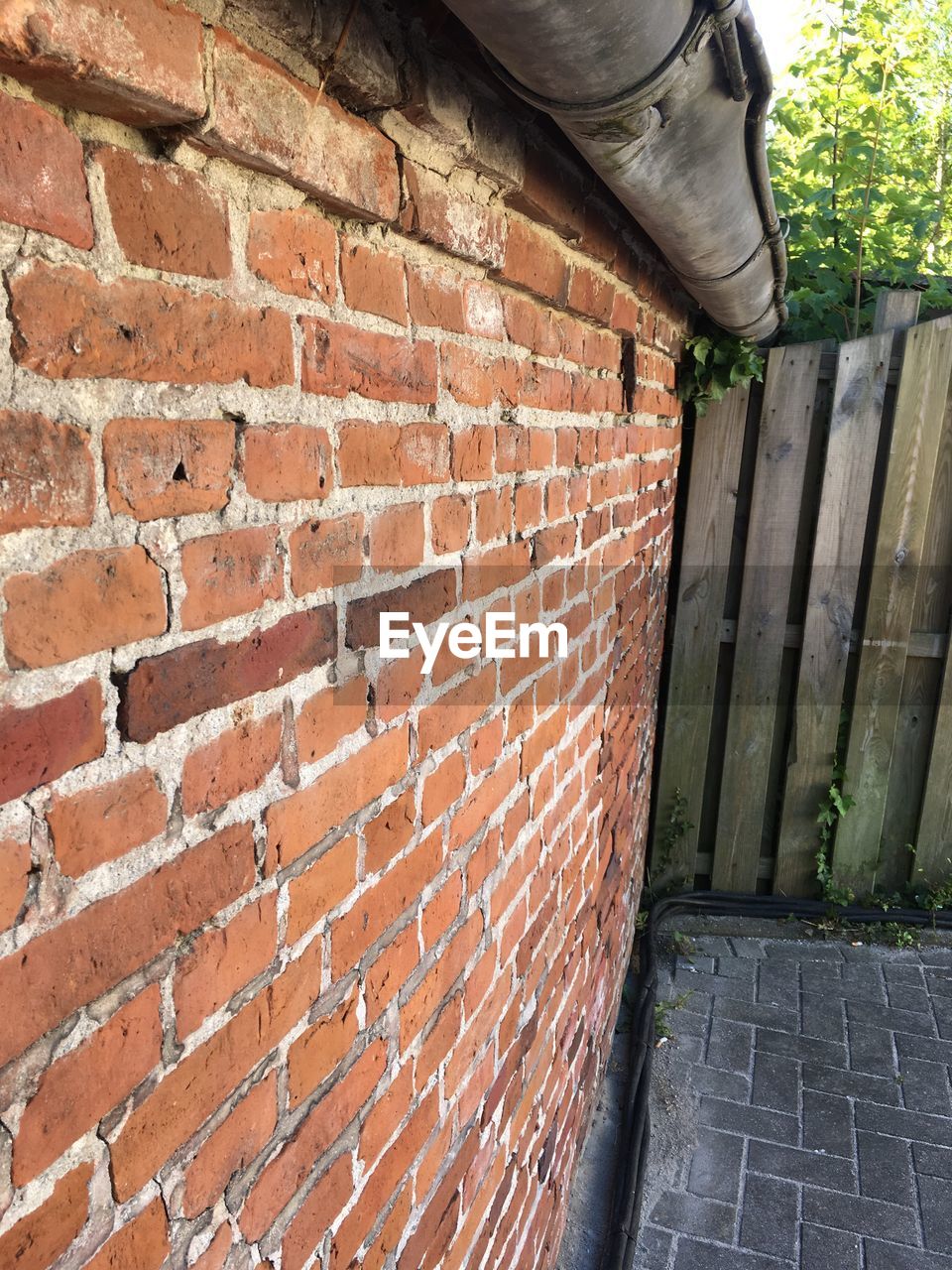 CLOSE-UP OF BRICK WALL WITH FOOTPATH