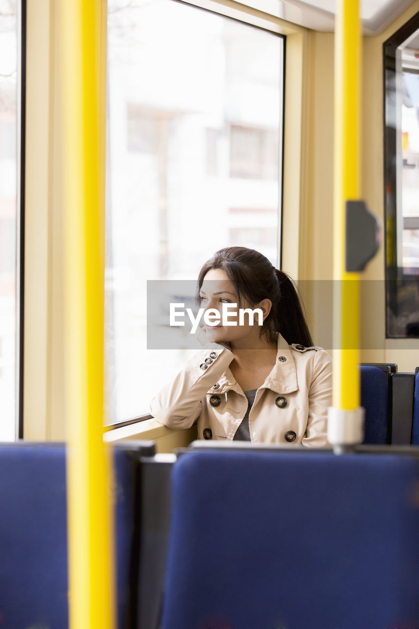 Woman in tram looking through window