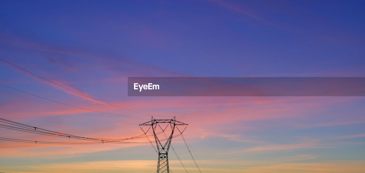 LOW ANGLE VIEW OF POWER LINES AGAINST SKY DURING SUNSET