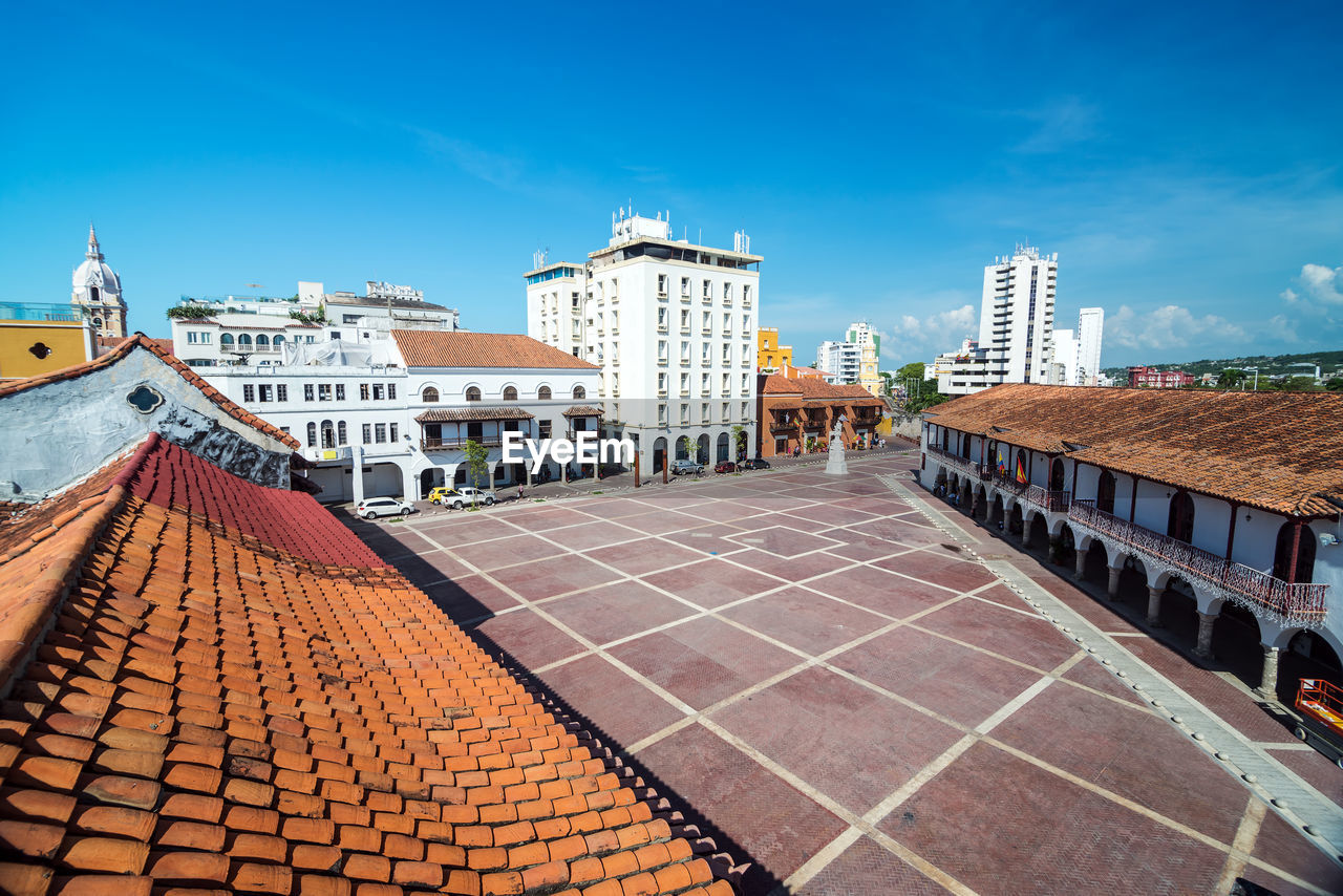 Buildings by plaza de la aduana against blue sky